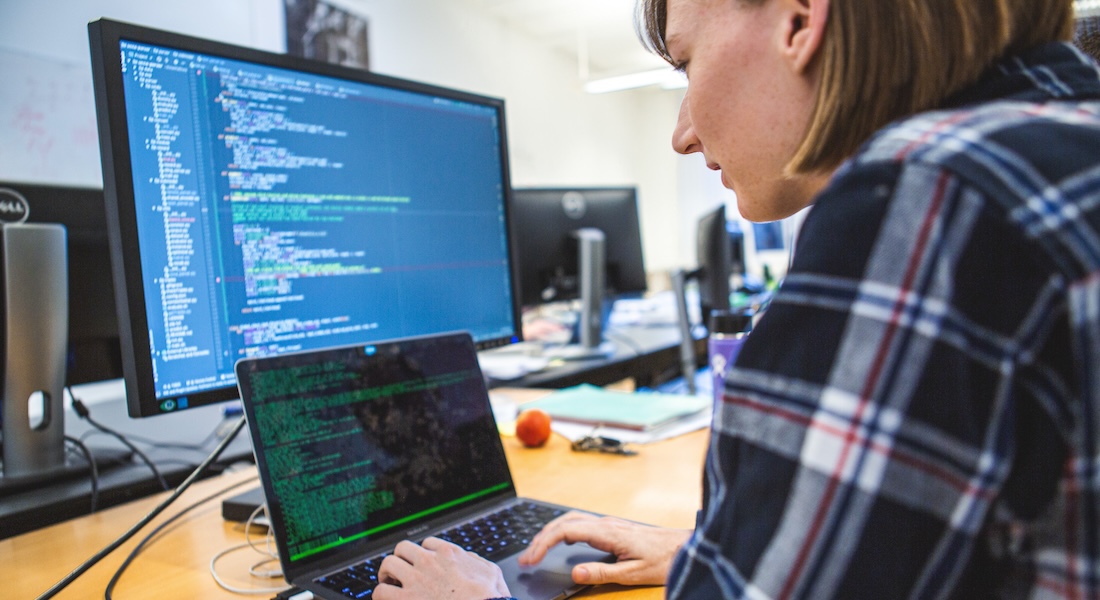 Woman in front of computer screens