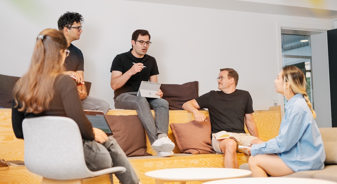 Colleagues discussing work in lounge area